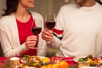 Image showing close up of couple drinking red wine on christmas