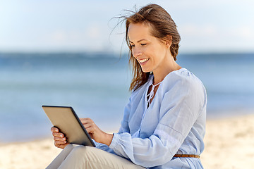 Image showing happy smiling woman with tablet pc on summer beach