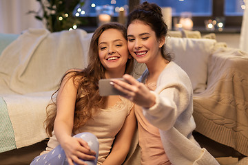 Image showing female friends taking selfie by smartphone at home