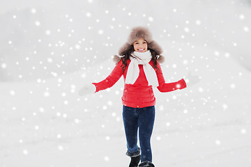 Image showing happy woman in winter fur hat outdoors