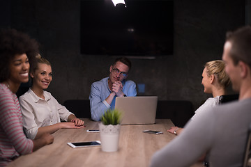 Image showing Multiethnic startup business team in night office