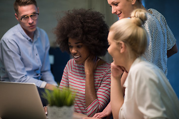 Image showing Multiethnic startup business team in night office