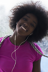 Image showing portrait of young afro american woman in gym while listening mus