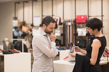 Image showing couple chooses shoes At Shoe Store