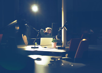 Image showing businessman sitting with legs on desk at office