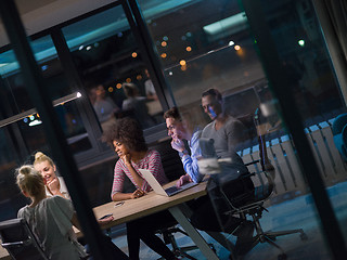 Image showing Multiethnic startup business team in night office