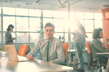 Image showing businessman working using a laptop in startup office