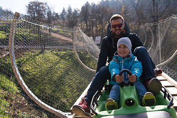 Image showing father and son enjoys driving on alpine coaster
