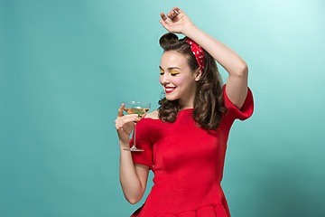 Image showing Beautiful young woman with pinup make-up and hairstyle. Studio shot on white background