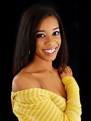 Image showing Young smiling black woman portrait against dark background