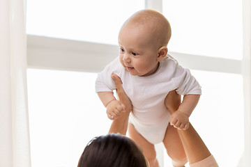 Image showing happy mother playing with little baby boy at home