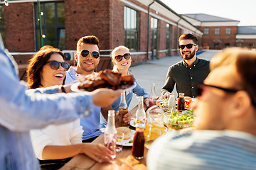 Image showing friends at barbecue party on rooftop in summer