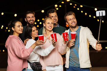 Image showing friends with drinks taking selfie at rooftop party