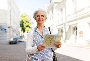 Image showing senior woman or tourist with map on city street