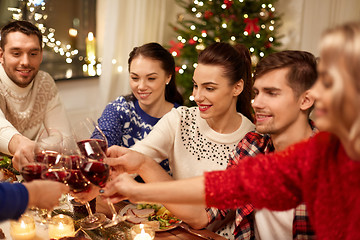 Image showing friends celebrating christmas and drinking wine