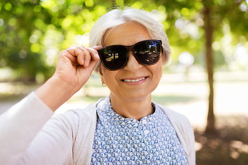 Image showing portrait of happy senior woman at summer park