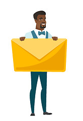 Image showing Smiling groom holding a big envelope.