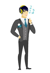 Image showing Groom listening to music in headphones.