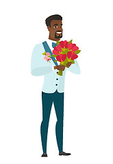 Image showing African groom holding a bouquet of flowers.