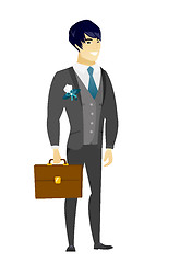 Image showing Asian groom holding briefcase.