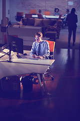 Image showing man working on computer in dark office