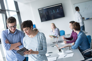 Image showing Two Business People Working With Tablet in office