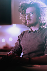 Image showing man working on computer in dark office