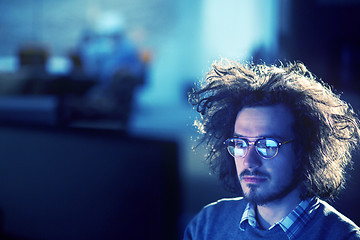 Image showing man working on computer in dark office