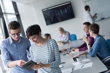 Image showing Two Business People Working With Tablet in office