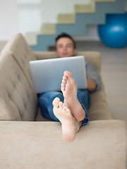 Image showing Man using laptop in living room