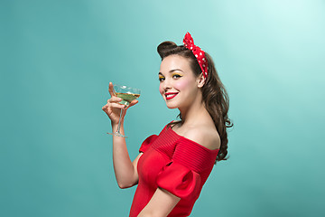 Image showing Beautiful young woman with pinup make-up and hairstyle. Studio shot on white background