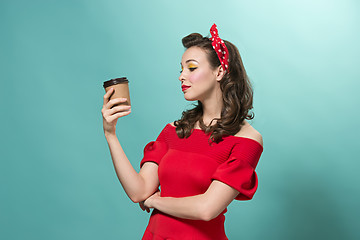 Image showing Beautiful young woman with pinup make-up and hairstyle. Studio shot on white background