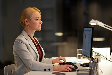 Image showing businesswoman at computer working at night office