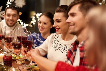 Image showing friends celebrating christmas and drinking wine