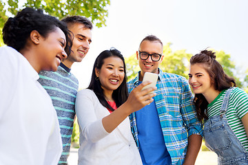 Image showing happy friends with smartphone at summer park