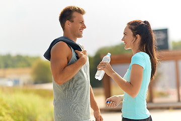 Image showing couple with bottle of water after doing sports