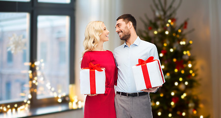 Image showing happy couple with christmas gifts at home