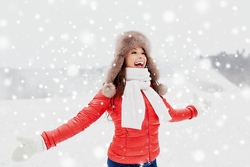 Image showing happy woman in winter fur hat having fun outdoors