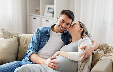 Image showing man hugging pregnant woman at home