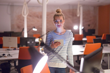 Image showing woman working on digital tablet in night office