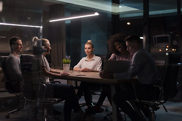 Image showing Multiethnic startup business team in night office