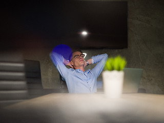 Image showing businessman relaxing at the desk