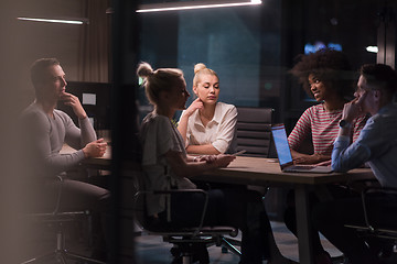 Image showing Multiethnic startup business team in night office