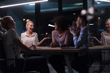 Image showing Multiethnic startup business team in night office