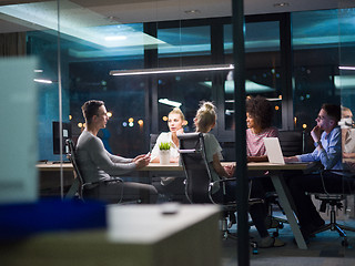 Image showing Multiethnic startup business team in night office