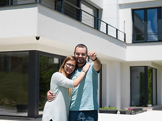 Image showing couple hugging in front of  new luxury home