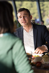 Image showing Closeup shot of young woman and man having meal.