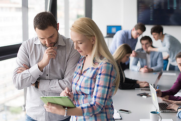 Image showing Two Business People Working With Tablet in office