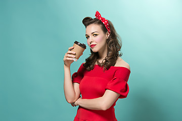 Image showing Beautiful young woman with pinup make-up and hairstyle. Studio shot on white background