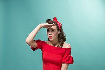 Image showing Beautiful young woman with pinup make-up and hairstyle. Studio shot on white background